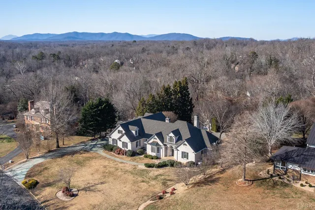 a view of an empty room with wooden floor and a fireplace