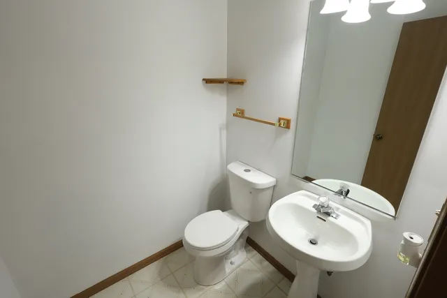 a white toilet sitting next to a bathroom sink