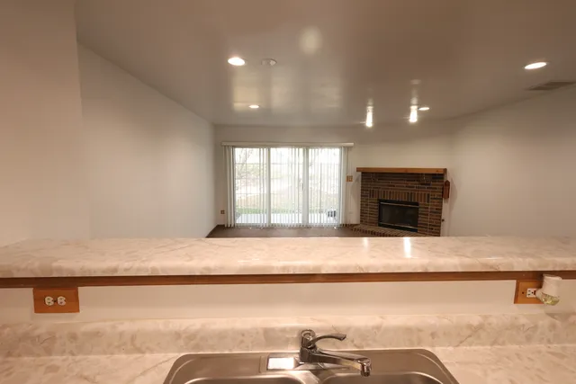 a living room with a fireplace furniture and a window