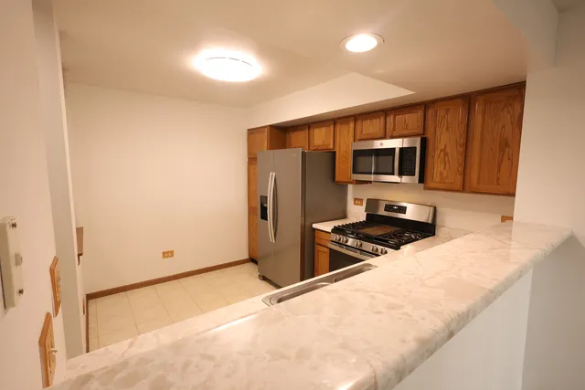 a kitchen with stainless steel appliances a microwave a stove and refrigerator