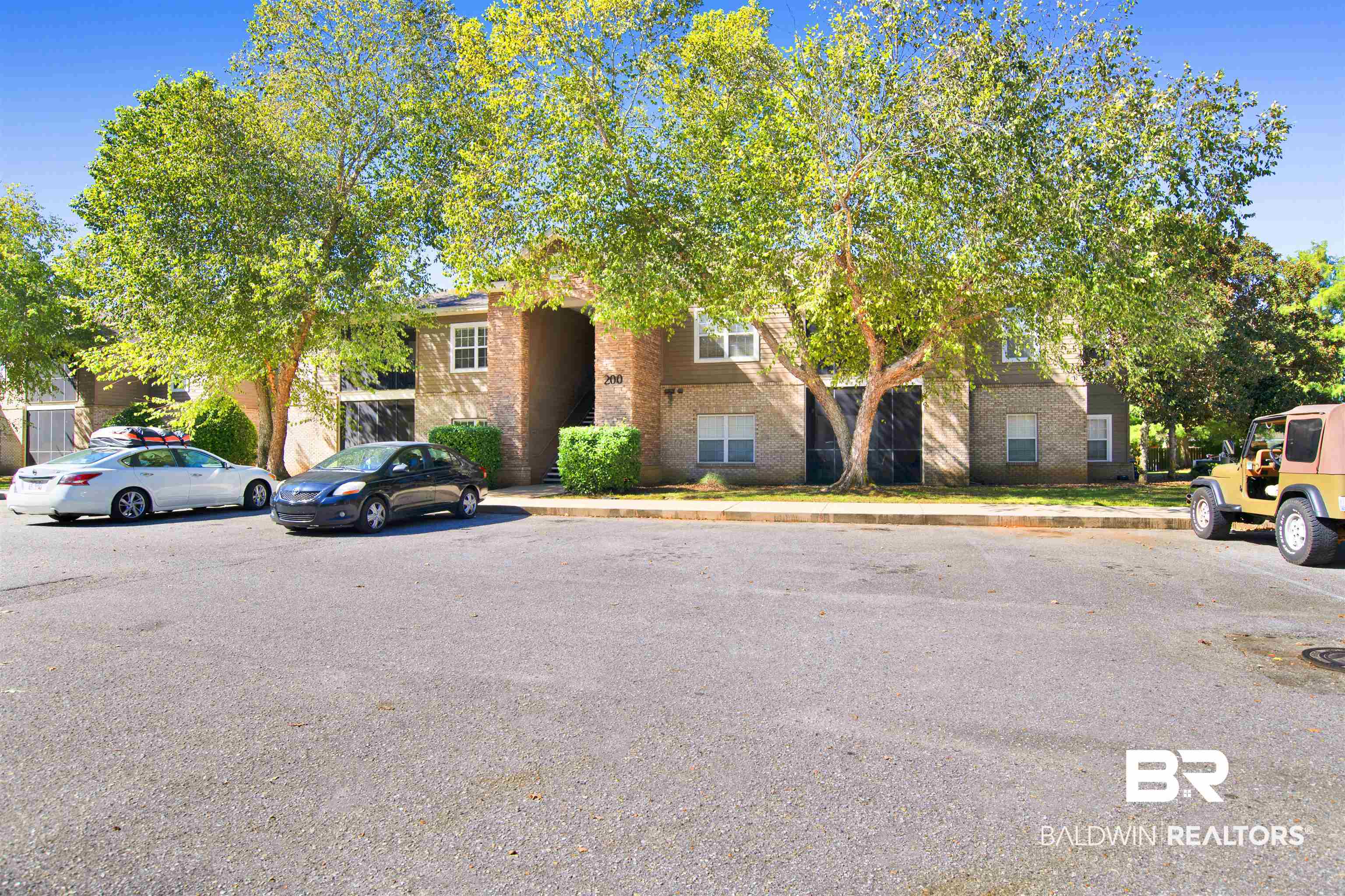 450 Park Avenue, Unit 202 Foley, AL 36535 - Photo 1 of 18 View of property hidden behind natural elements with brick siding