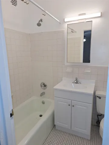 a bathroom with a bathtub a sink a toilet and a mirror
