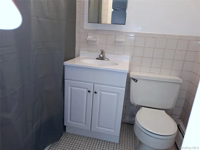 a bathroom with a sink toilet and a mirror