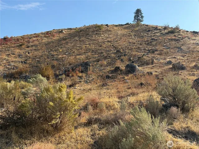 a view of a large building with mountains in the background