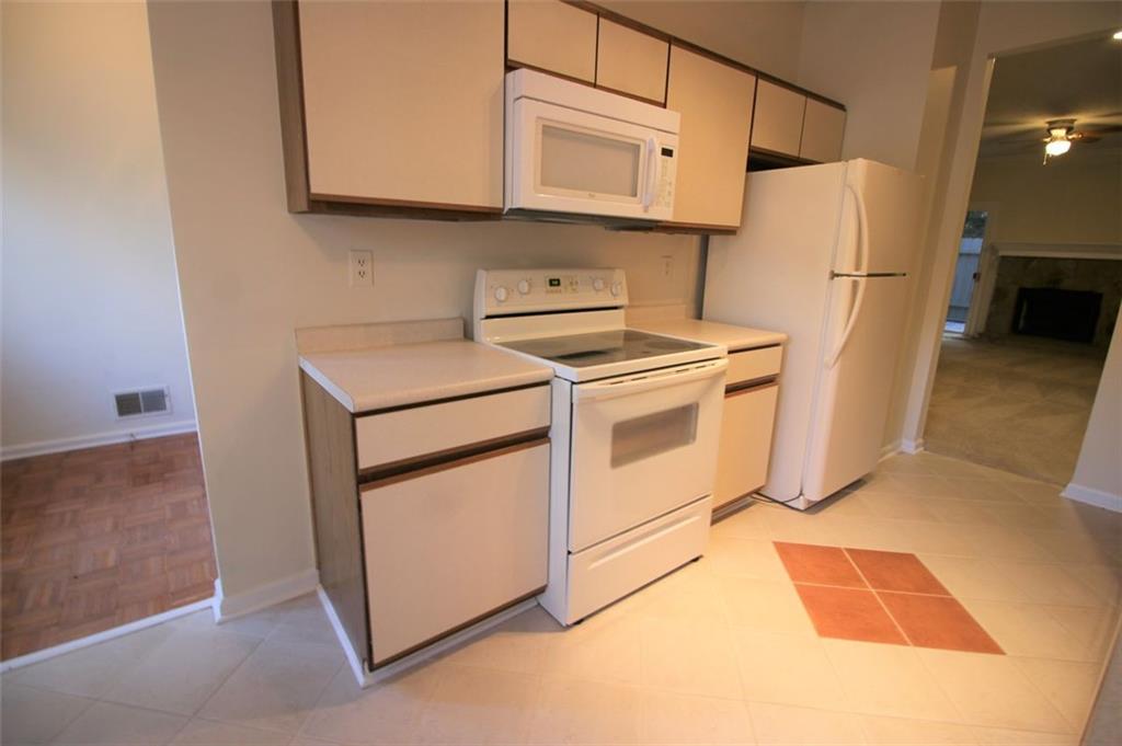 a kitchen with stainless steel appliances white cabinets and a refrigerator
