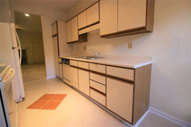 a kitchen with stainless steel appliances granite countertop a sink and a refrigerator