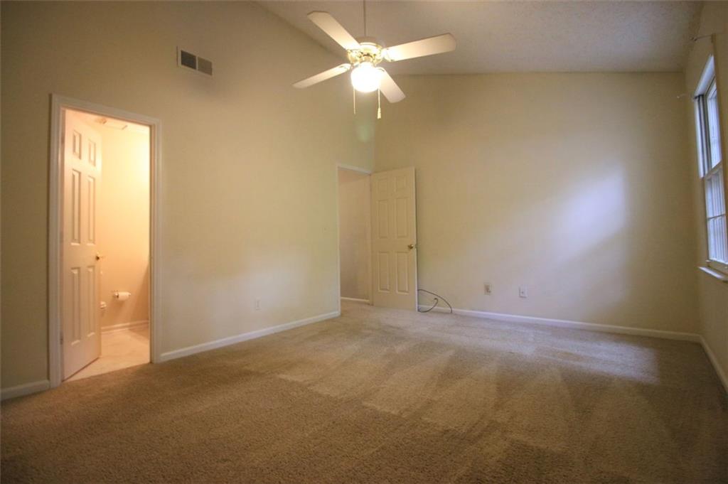 4028 Elm Street Chamblee, GA 30341 - Photo 5 of 13 an empty room with a fan & a window