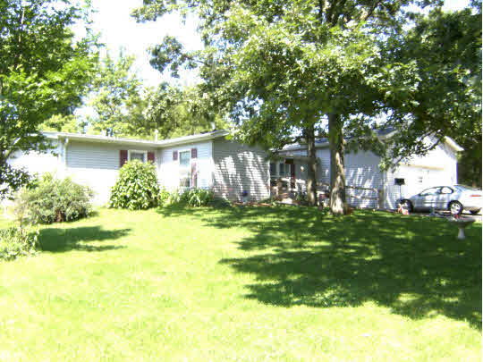 8299 Friday Road Davis Junction, IL 61020 - Photo 1 of 10 a front view of a house with garden