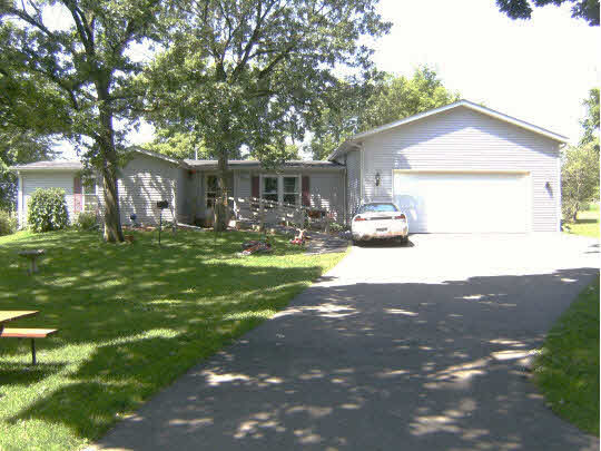 8299 Friday Road Davis Junction, IL 61020 - Photo 2 of 10 a backyard of a house with yard and outdoor seating