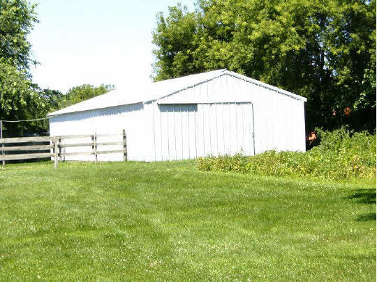 8299 Friday Road Davis Junction, IL 61020 - Photo 5 of 10 a view of a backyard with grass and plants