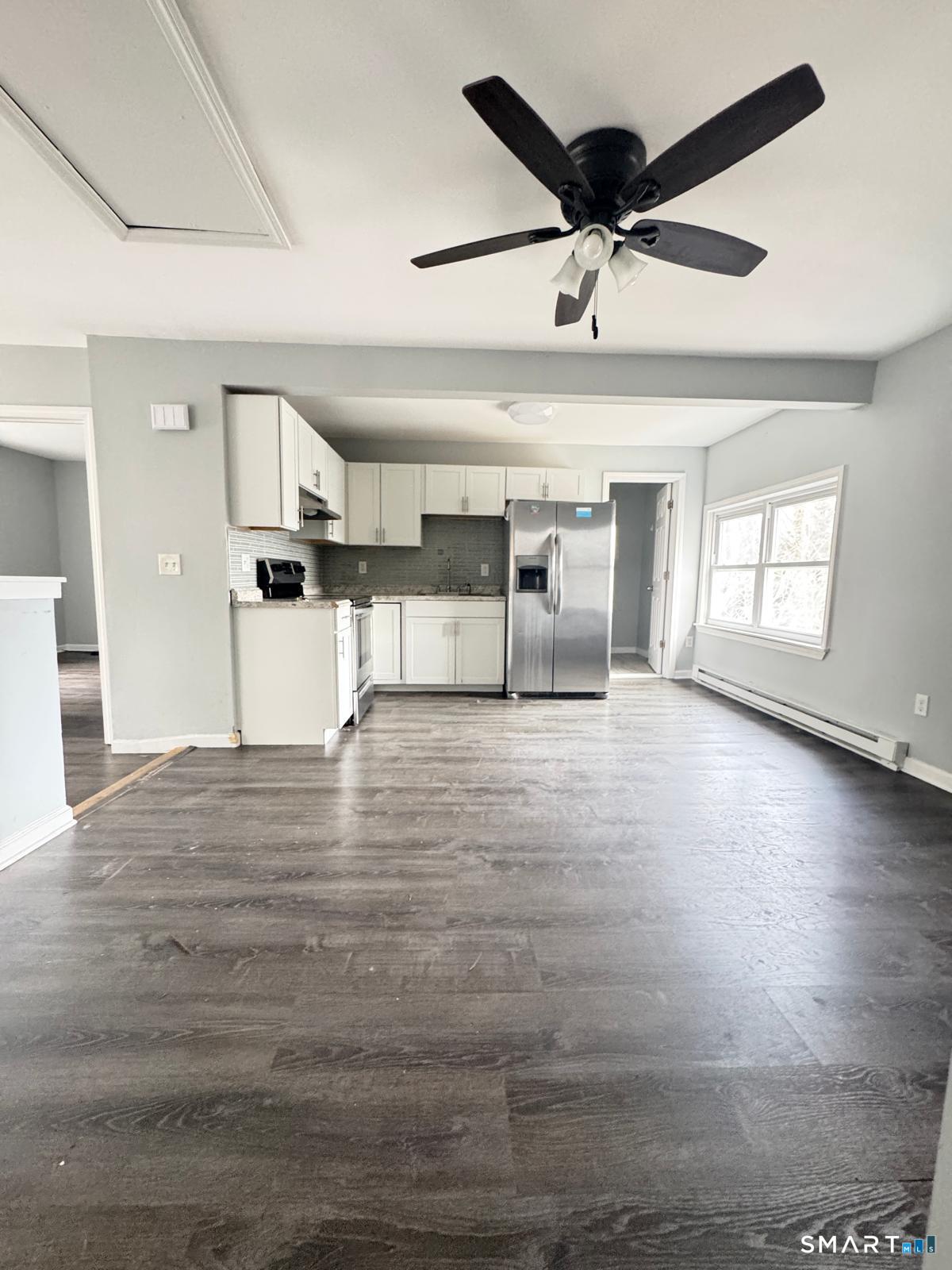 33 Pond Street Naugatuck, CT 06770 - Photo 2 of 8 an empty room with wooden floor and windows