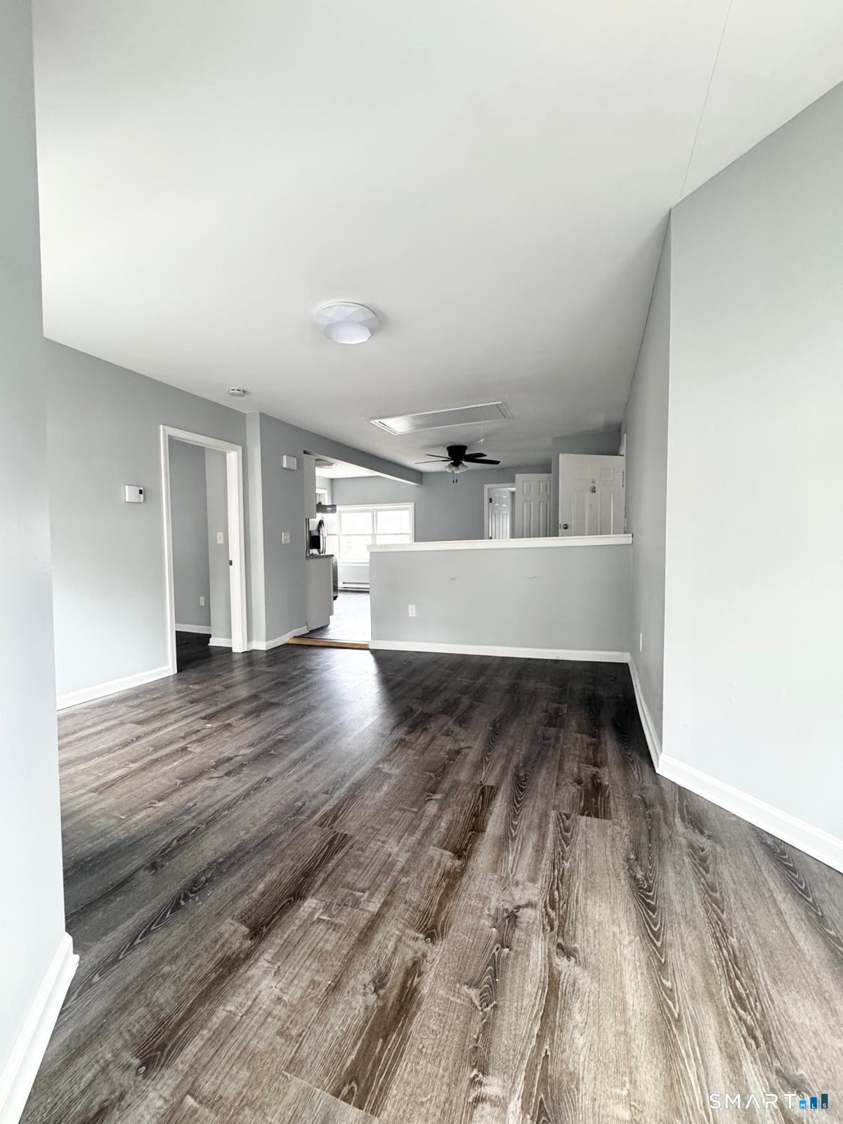 33 Pond Street Naugatuck, CT 06770 - Photo 3 of 8 a view of wooden floor and windows in a room