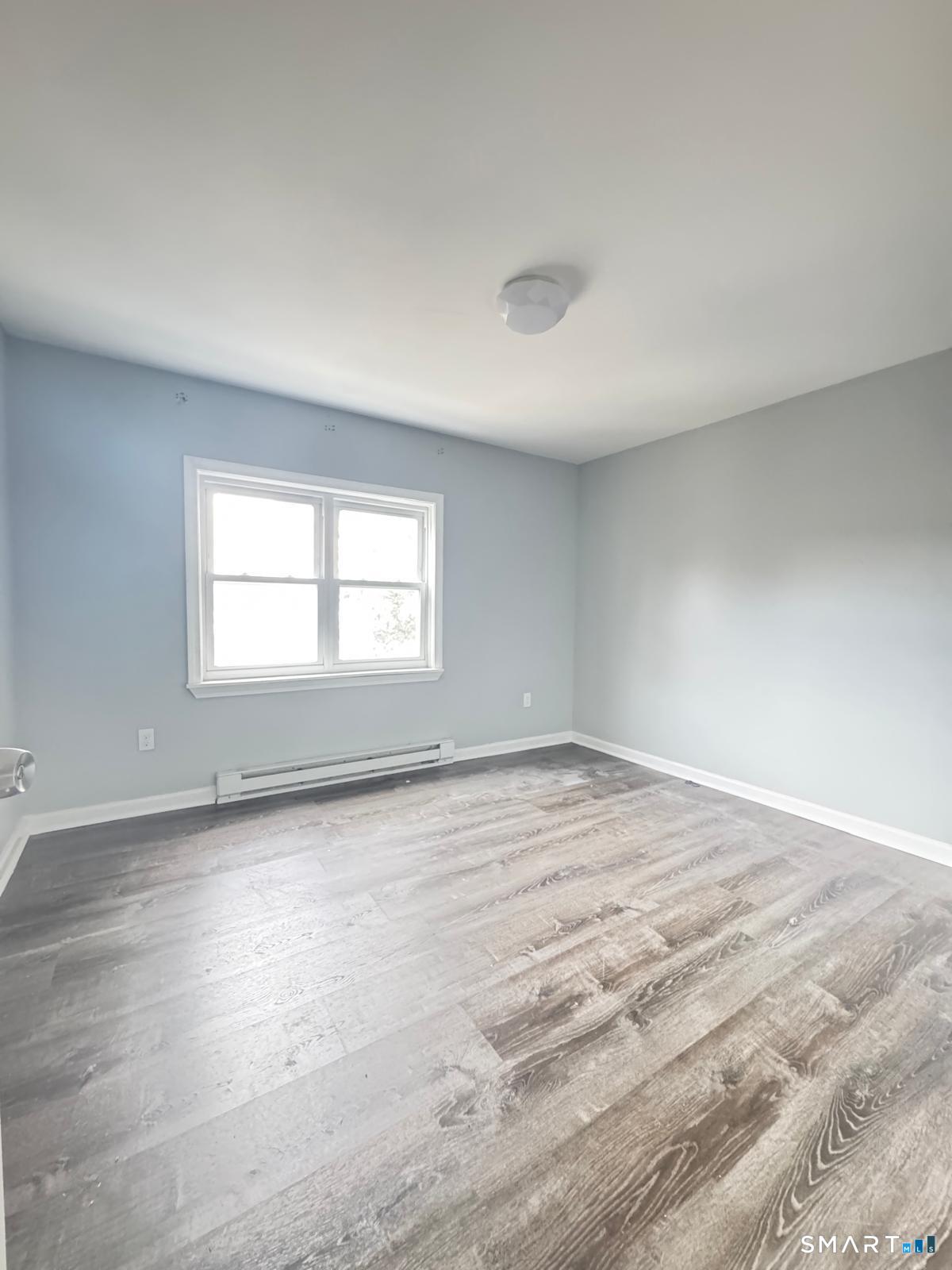 33 Pond Street Naugatuck, CT 06770 - Photo 5 of 8 a view of an empty room with wooden floor and a window