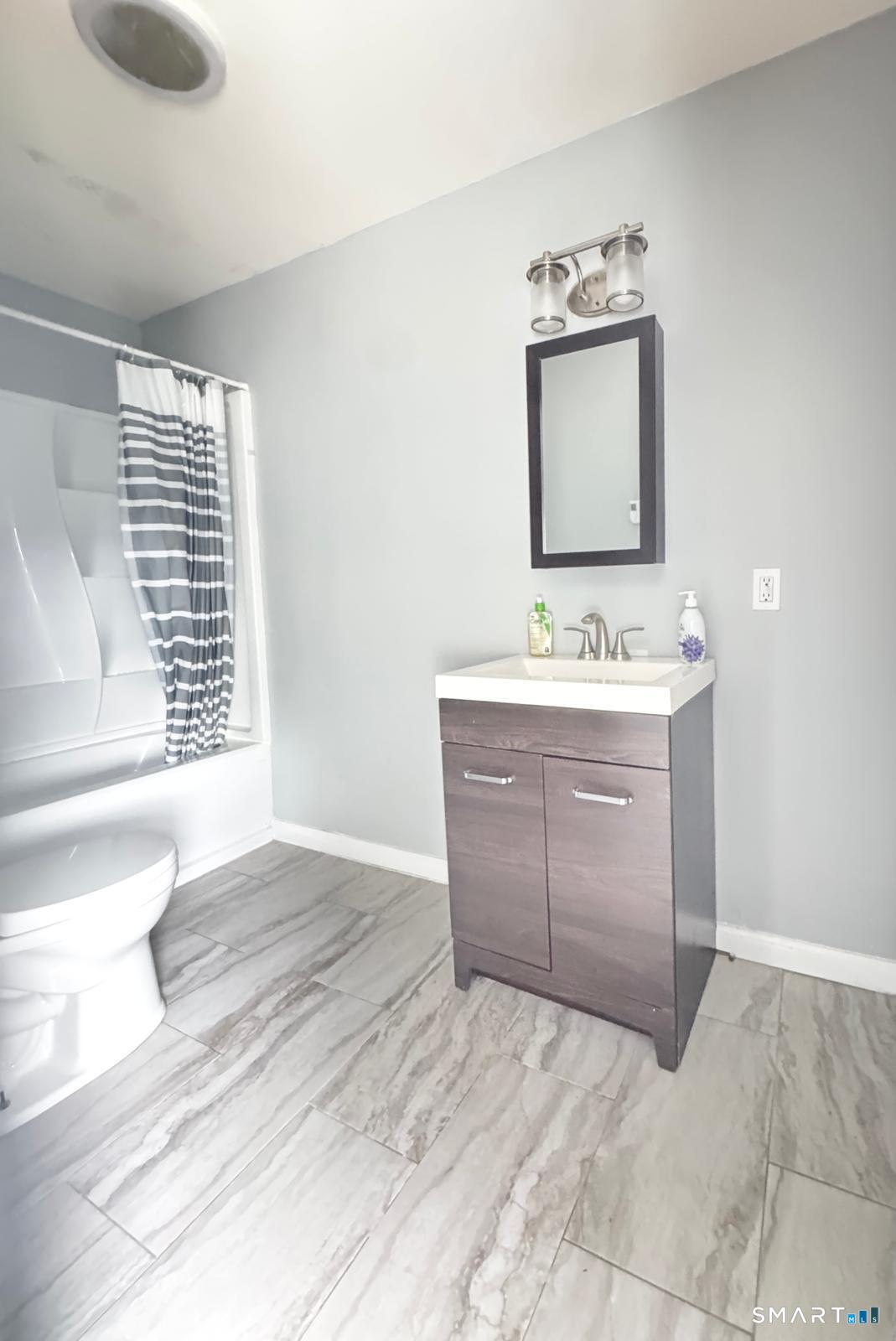 33 Pond Street Naugatuck, CT 06770 - Photo 6 of 8 a bathroom with a sink vanity and mirror