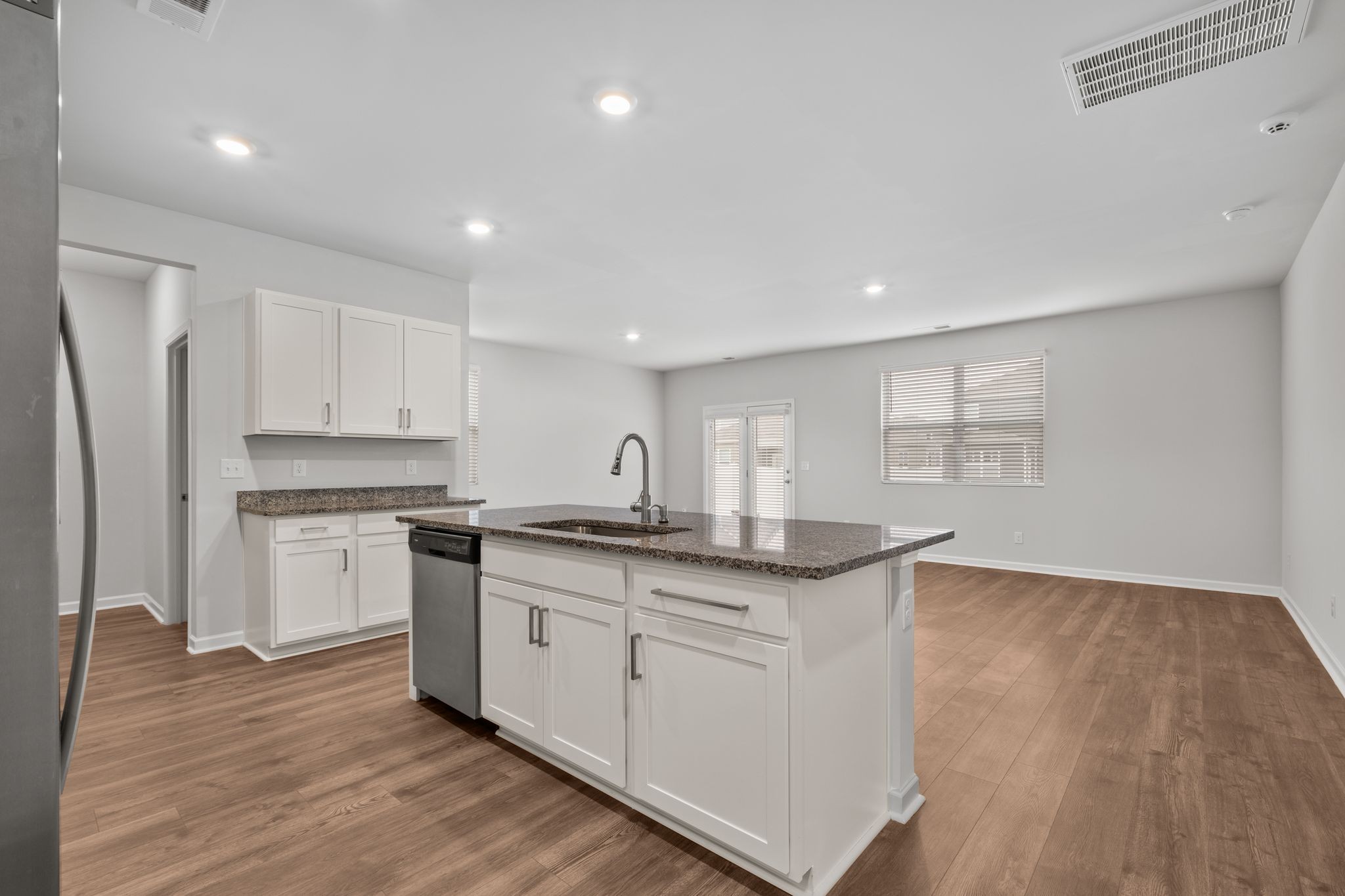 626 Pine Bloom Road Lebanon, TN 37087 - Photo 6 of 39 a kitchen with granite countertop white cabinets and refrigerator