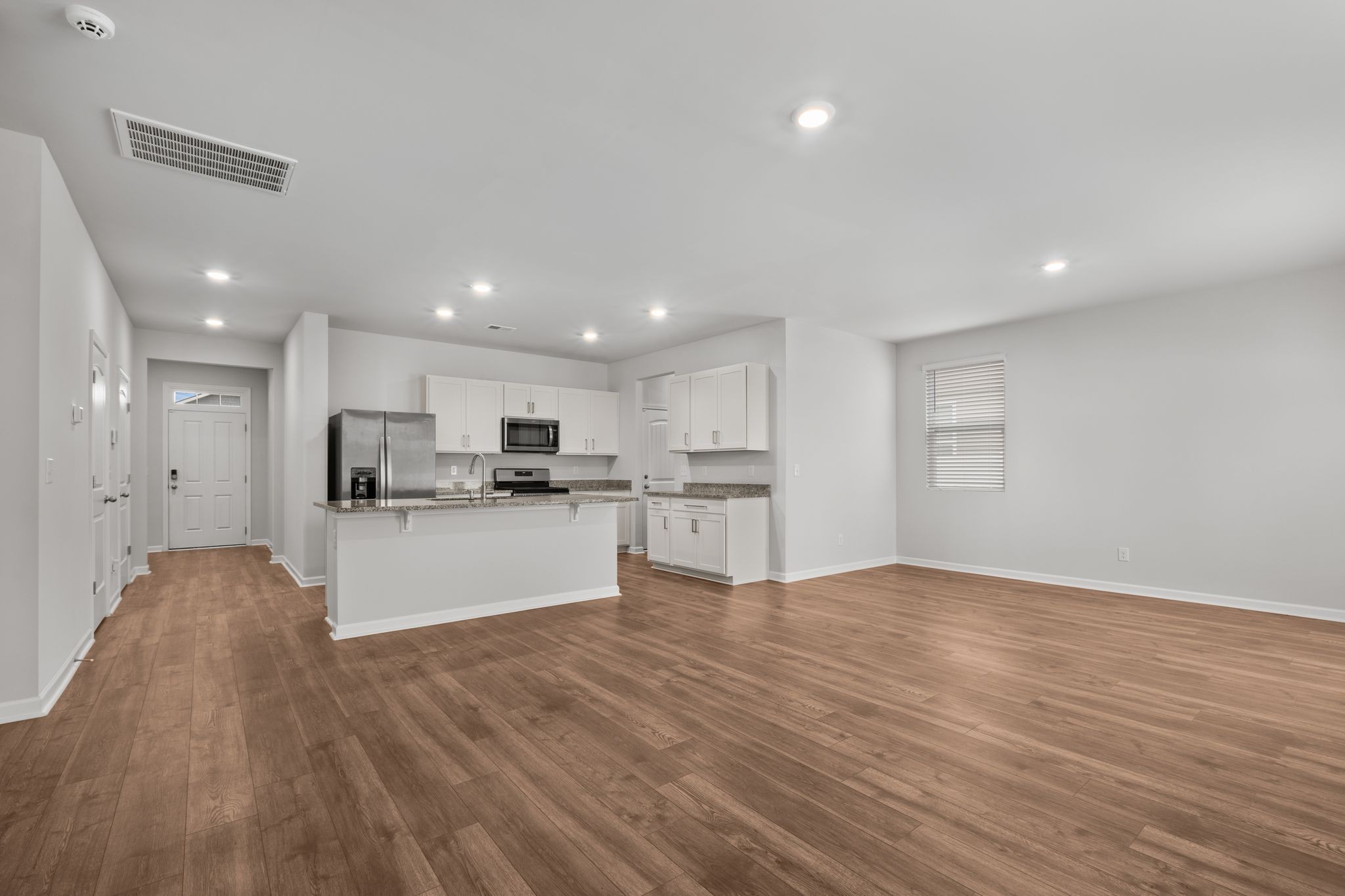 626 Pine Bloom Road Lebanon, TN 37087 - Photo 9 of 39 a view of kitchen with kitchen island a sink white cabinets and stainless steel appliances
