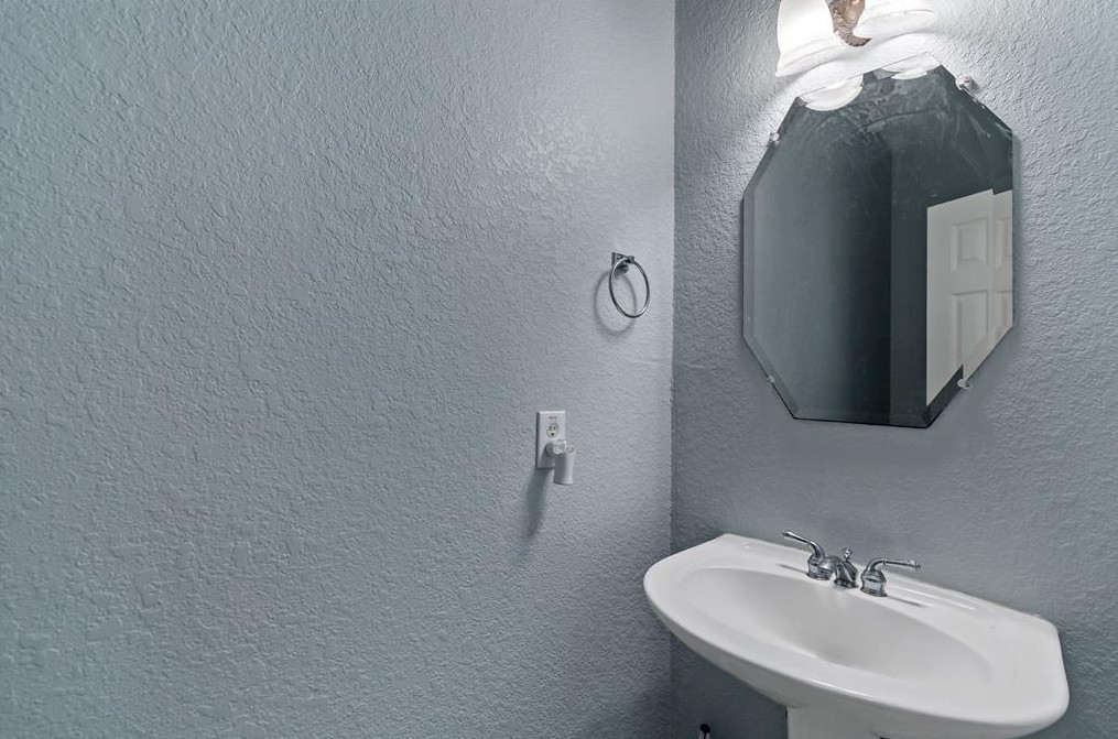 2611 South Breeze Drive Manvel, TX 77578 - Photo 13 of 20 a bathroom with a sink and mirror