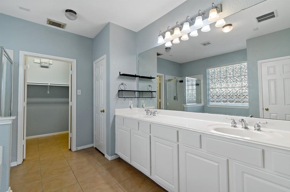2611 South Breeze Drive Manvel, TX 77578 - Photo 15 of 20 a spacious bathroom with a double vanity sink a large mirror and a shower