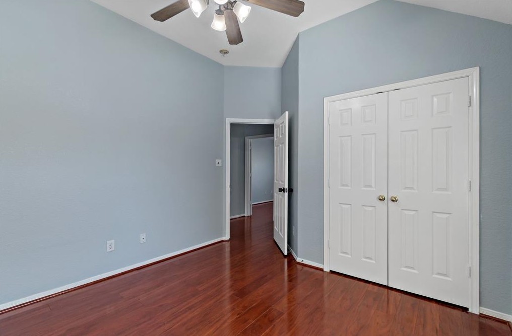 2611 South Breeze Drive Manvel, TX 77578 - Photo 16 of 20 a view of an empty room with wooden floor