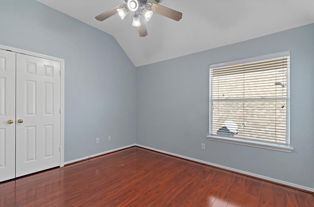2611 South Breeze Drive Manvel, TX 77578 - Photo 17 of 20 a view of an empty room with wooden floor and a window