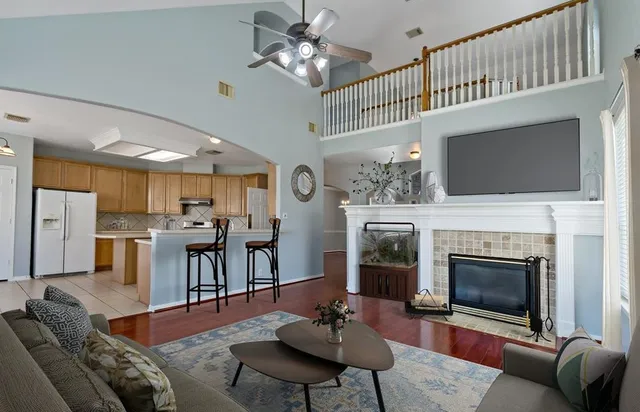 a living room with furniture a fireplace and a flat screen tv