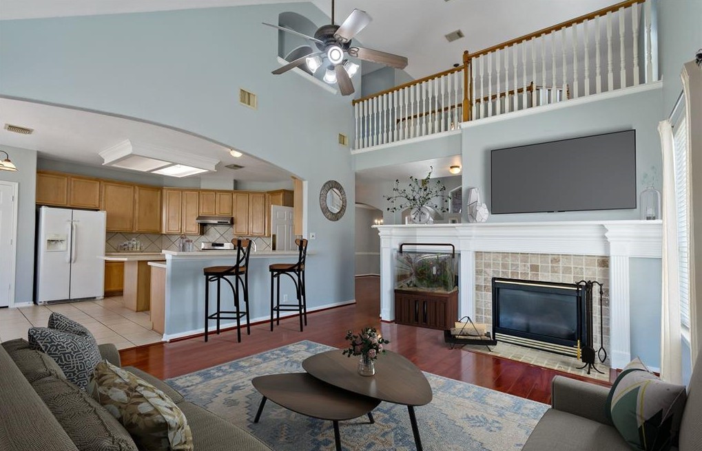 2611 South Breeze Drive Manvel, TX 77578 - Photo 2 of 20 a living room with furniture a fireplace and a flat screen tv
