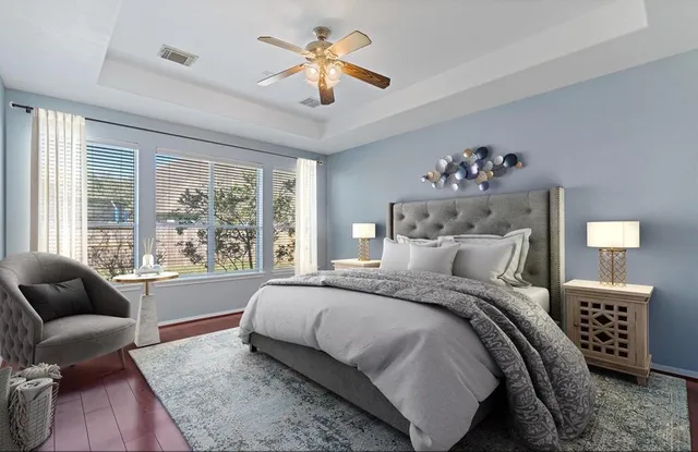 a bedroom with a large bed couch and a window