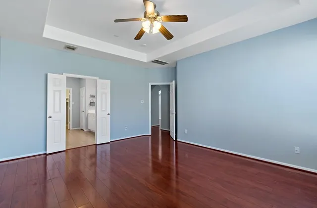 a view of an empty room with wooden floor