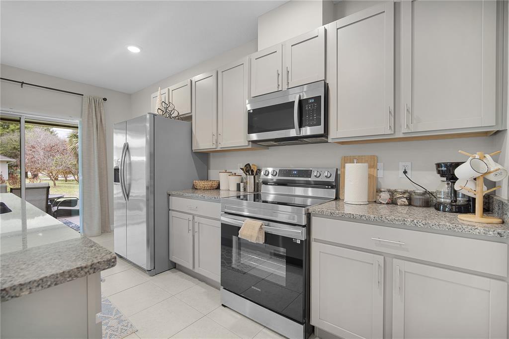 418 Fleming Street Sebastian, FL 32958 - Photo 8 of 38 a kitchen with stainless steel appliances granite countertop white cabinets and a sink