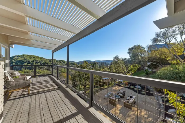 a view of a hallway with wooden floor and windows