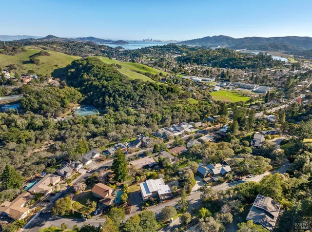 an aerial view of residential house with swimming pool and mountain view