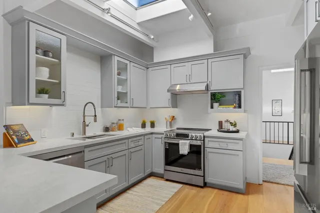 a kitchen with stainless steel appliances white cabinets and a stove