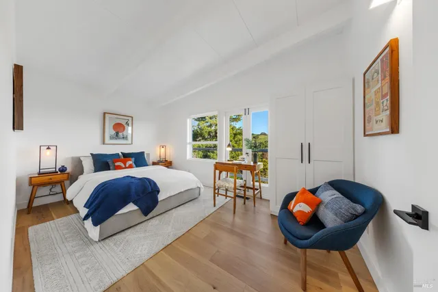 a view of a utility room with a sink and wooden floor