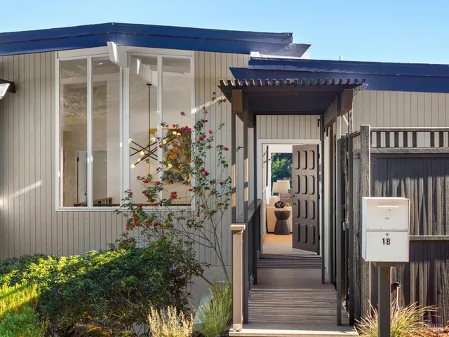 a view of a hallway with wooden floor and stairs