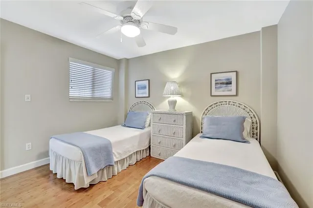 a bedroom with two beds and a chandelier