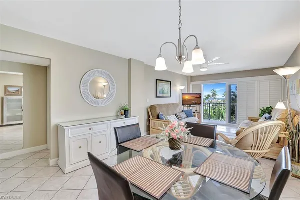 a living room with fireplace furniture and a large window
