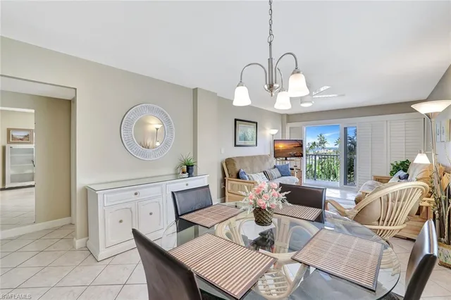 a living room with fireplace furniture and a large window