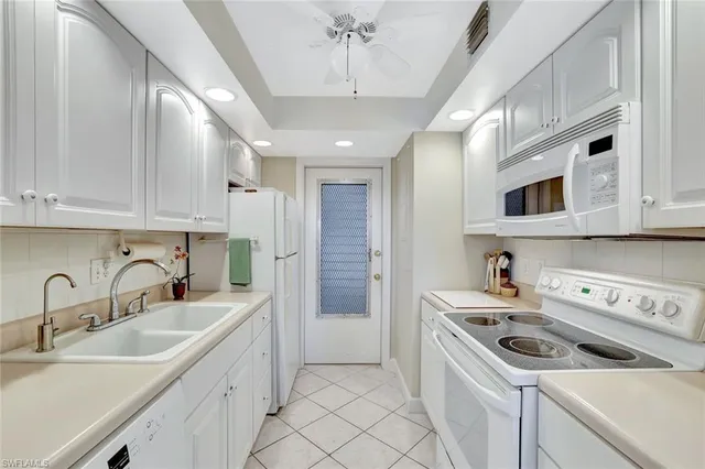 a kitchen with stainless steel appliances granite countertop a sink and a stove