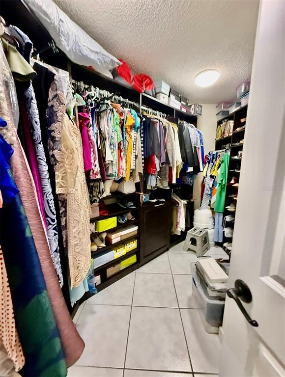 9611 Cypress Brook Road Tampa, FL 33647 - Photo 11 of 16 a view of walk in closet with clothes and shoes