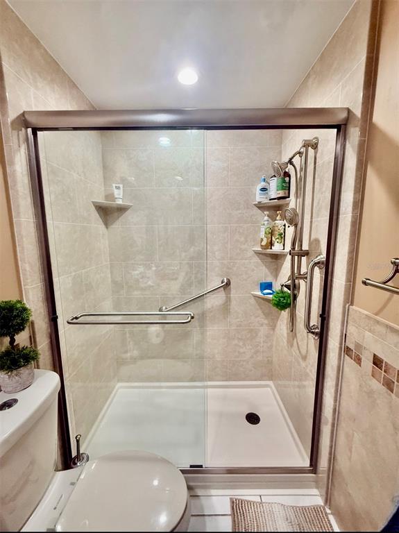 9611 Cypress Brook Road Tampa, FL 33647 - Photo 12 of 16 a bathroom with a glass shower door