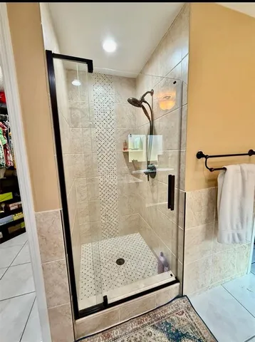 a bathroom with a tub sink and mirror