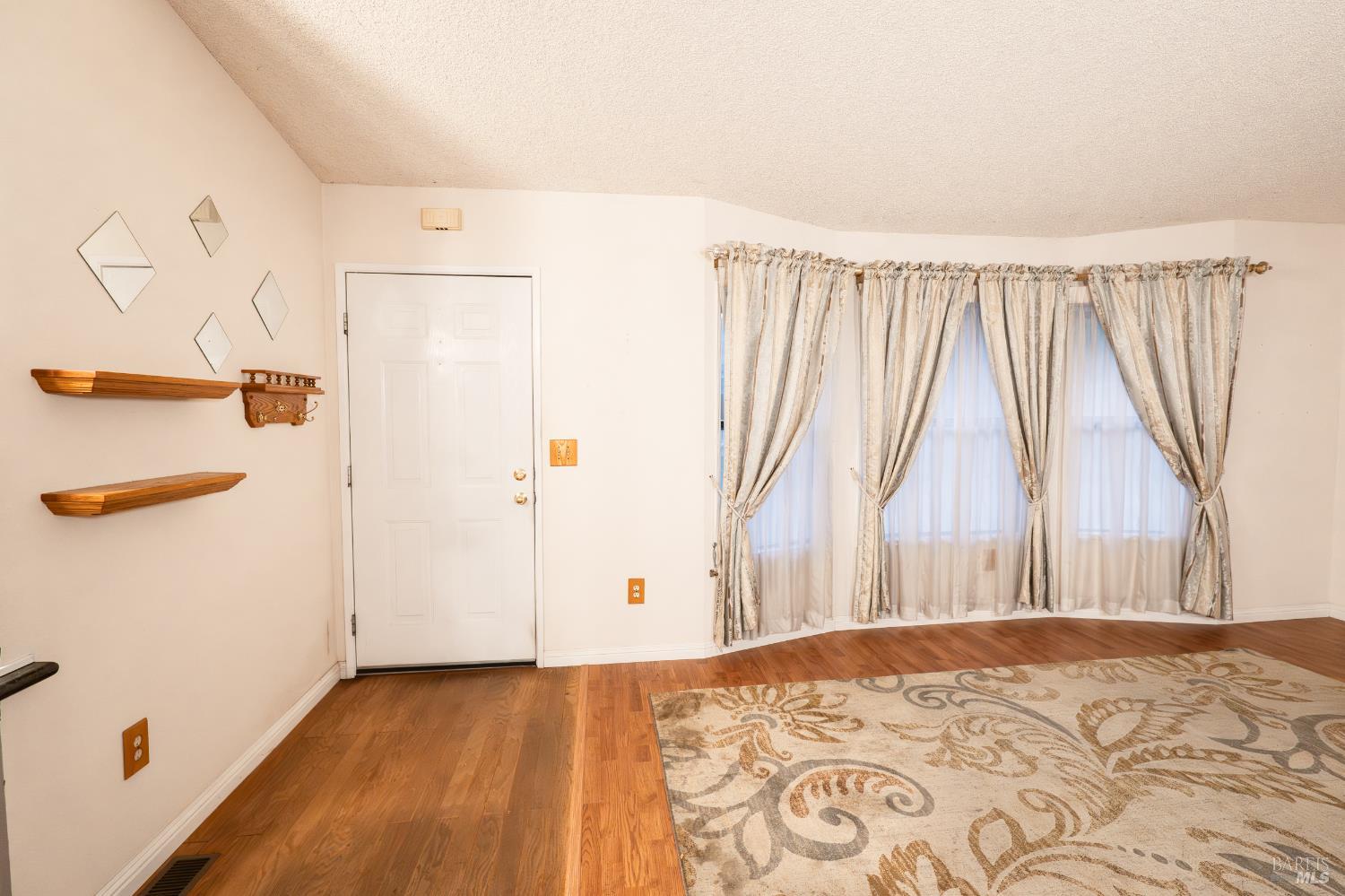 2555 Flosden Road, Unit 117 American Canyon, CA 94503 - Photo 11 of 36 a view of a bedroom with wooden floor and a window