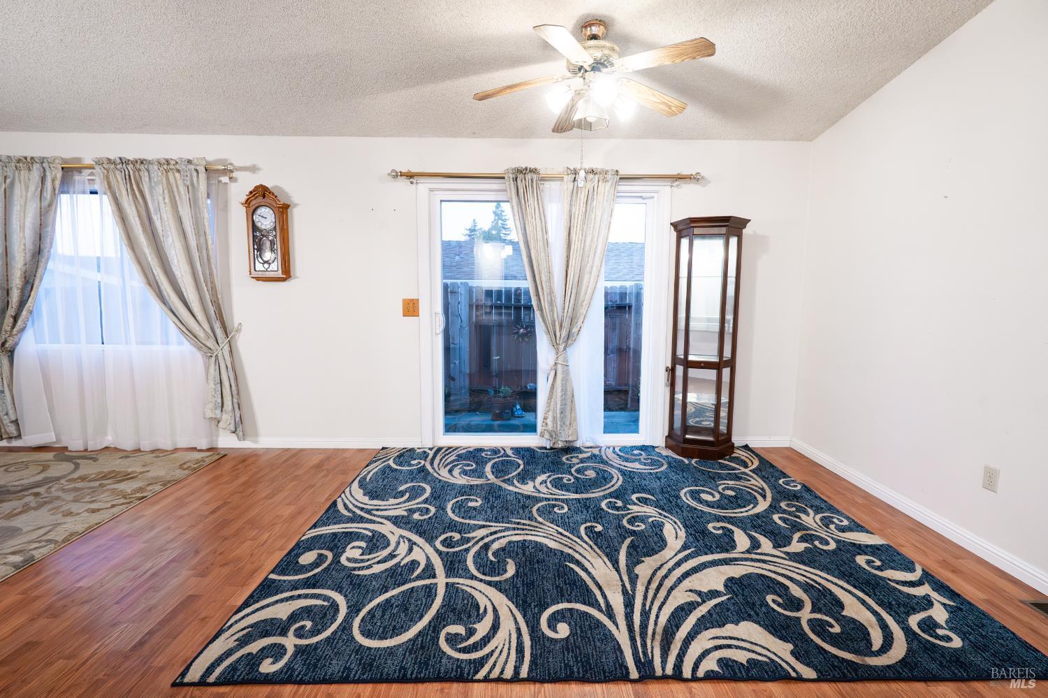 2555 Flosden Road, Unit 117 American Canyon, CA 94503 - Photo 12 of 36 a bedroom with a large bed and a chandelier