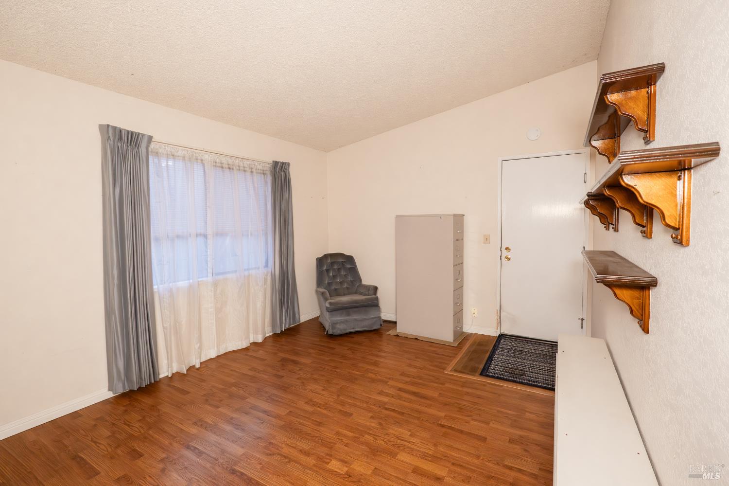 2555 Flosden Road, Unit 117 American Canyon, CA 94503 - Photo 18 of 36 a bedroom with a bed and wooden floor