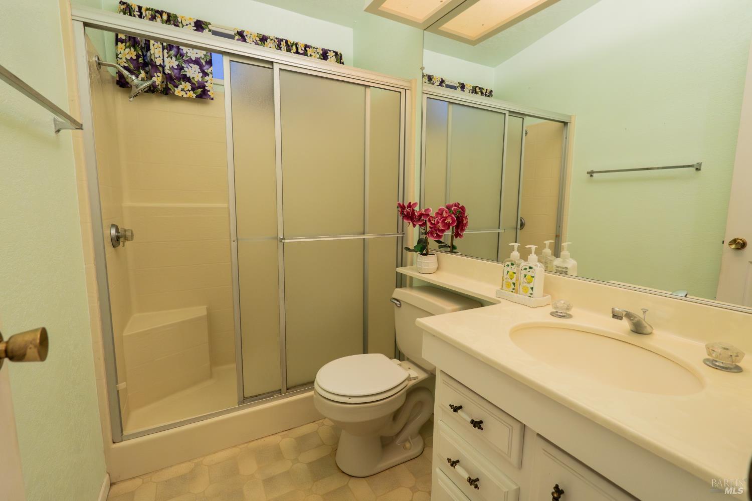 2555 Flosden Road, Unit 117 American Canyon, CA 94503 - Photo 20 of 36 a bathroom with a sink vanity granite toilet and shower