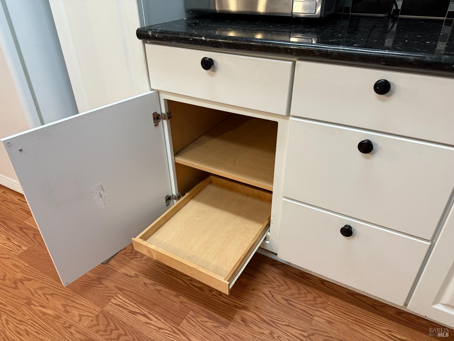 2555 Flosden Road, Unit 117 American Canyon, CA 94503 - Photo 25 of 36 a close view of kitchen island with a sink wooden floor and cabinets