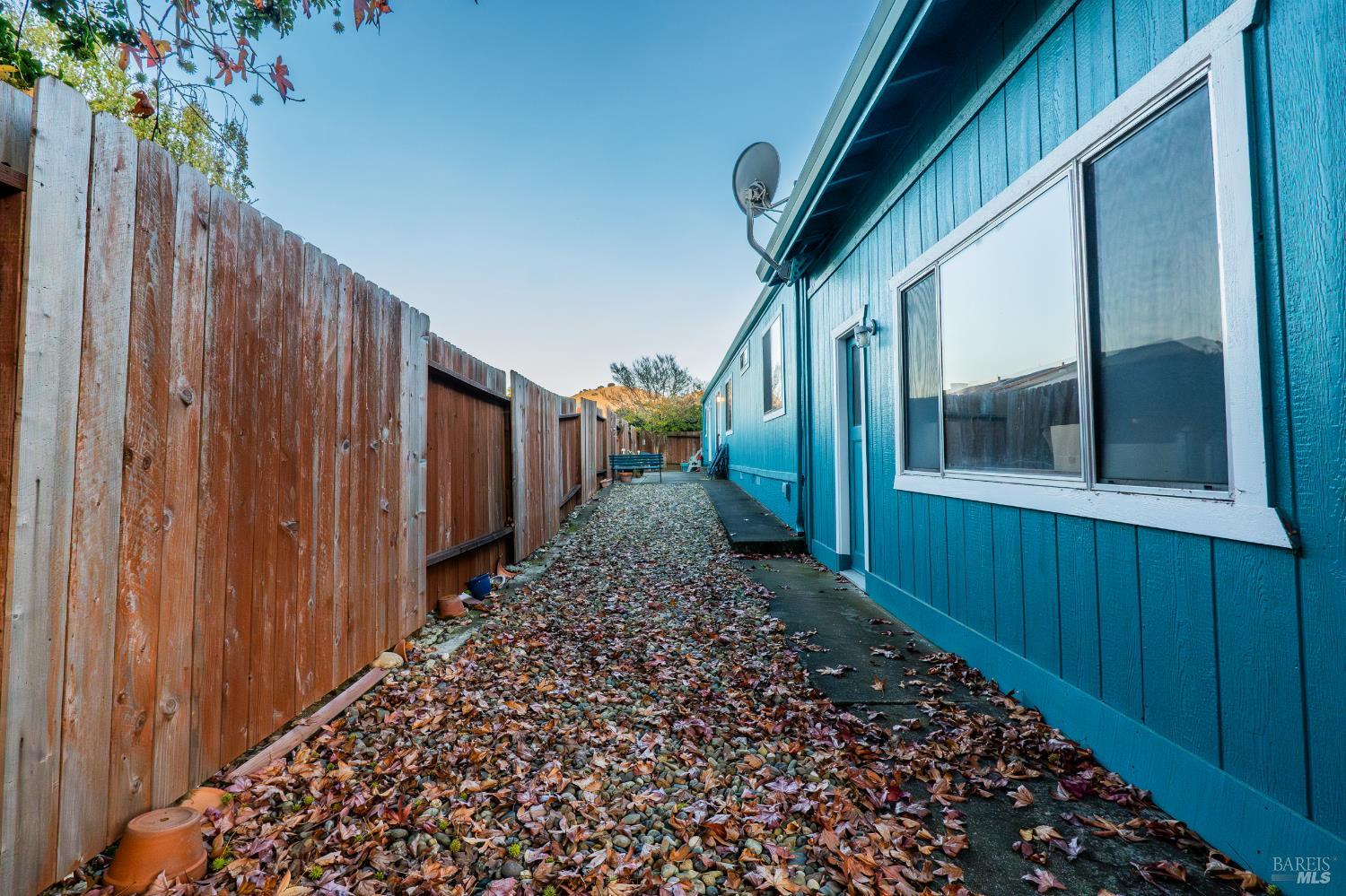 2555 Flosden Road, Unit 117 American Canyon, CA 94503 - Photo 29 of 36 a view of a pathway of a house with wooden fence