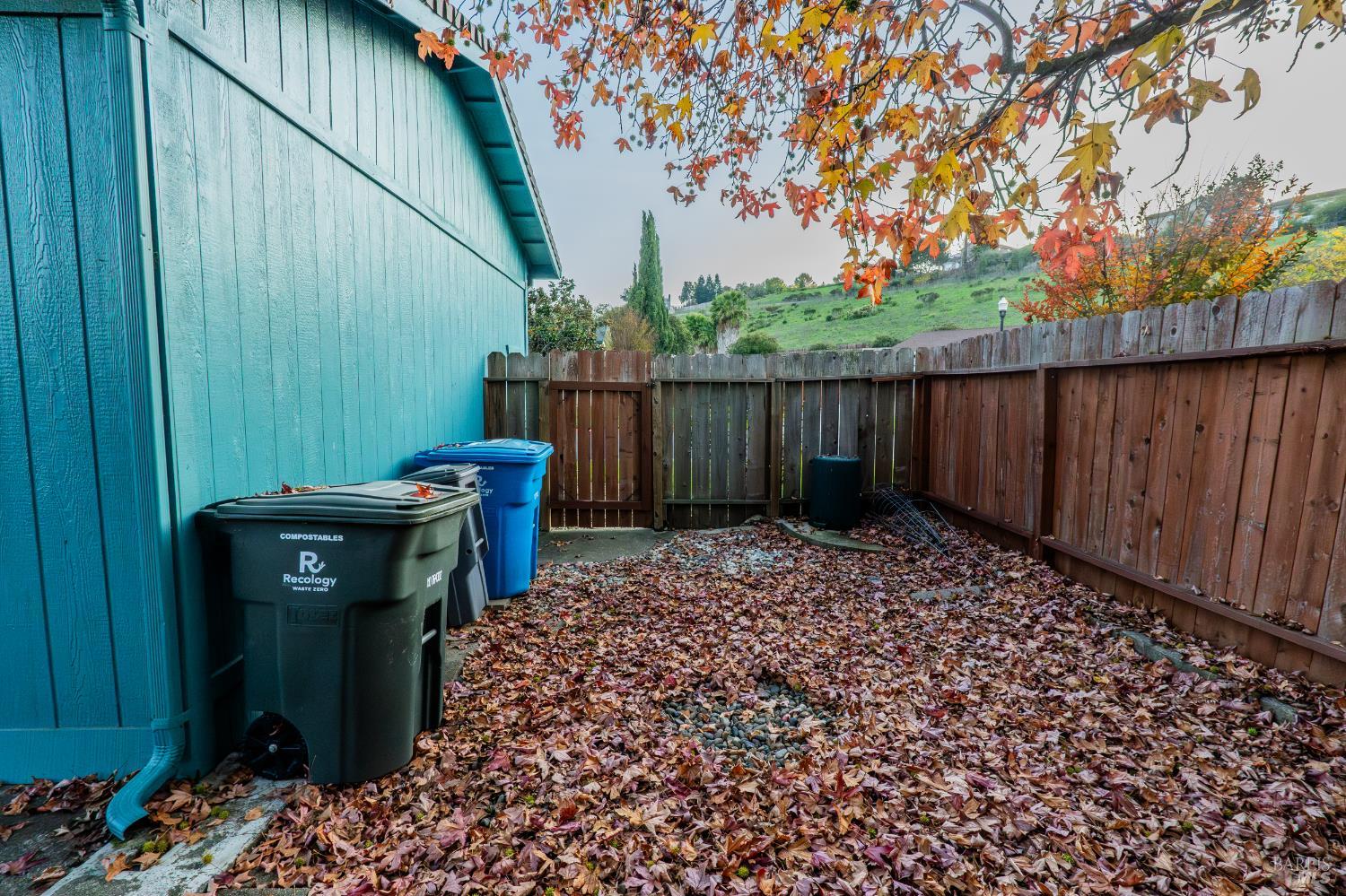 2555 Flosden Road, Unit 117 American Canyon, CA 94503 - Photo 30 of 36 a view of a backyard with a large tree and wooden fence