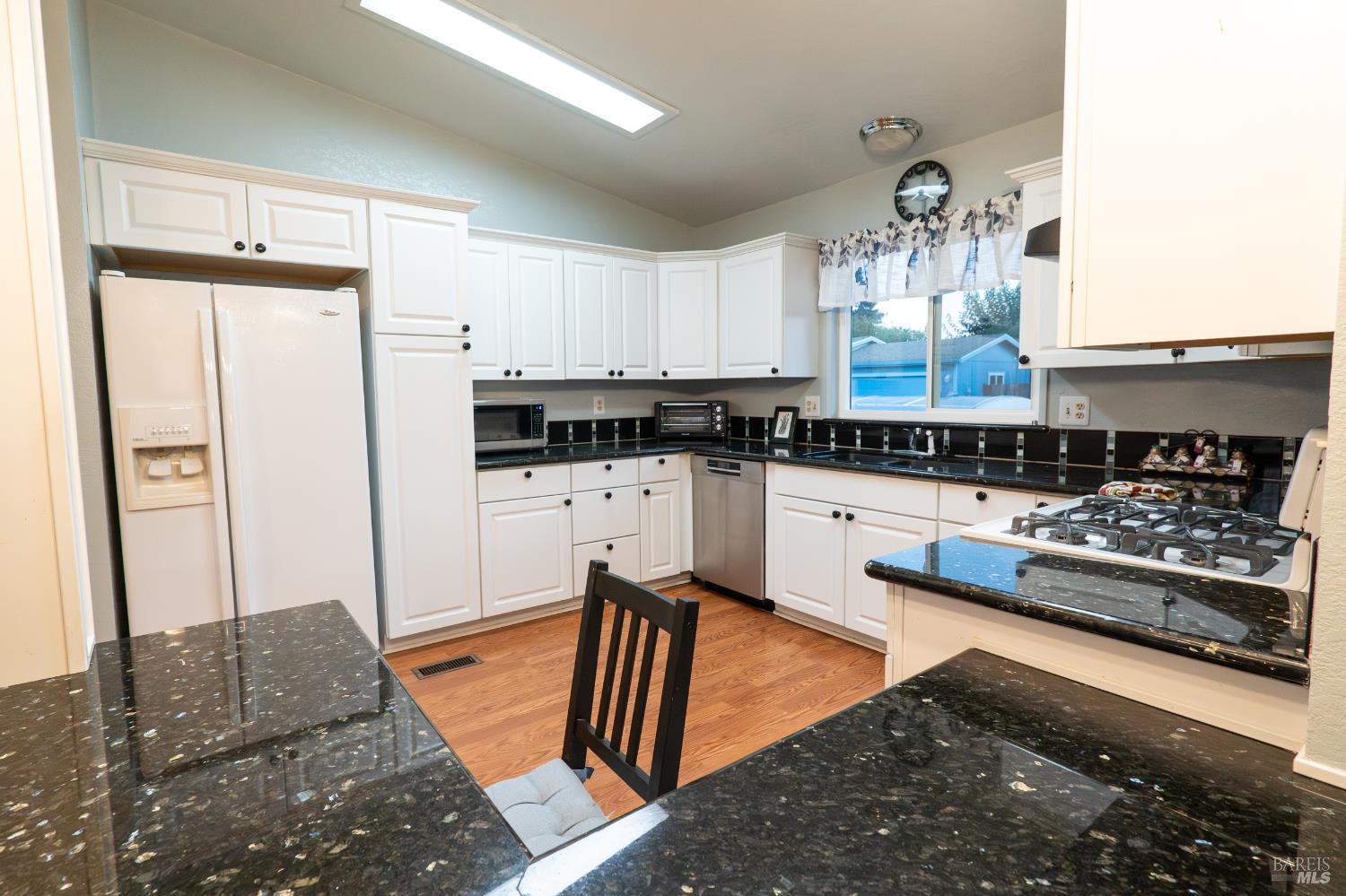 2555 Flosden Road, Unit 117 American Canyon, CA 94503 - Photo 8 of 36 a kitchen with stainless steel appliances granite countertop a sink stove and refrigerator