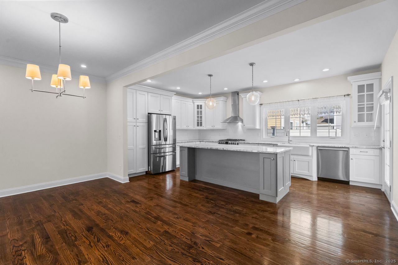 67 Boston Post Road, Unit 8 Madison, CT 06443 - Photo 11 of 35 Kitchen and dining area with designer light fixture
